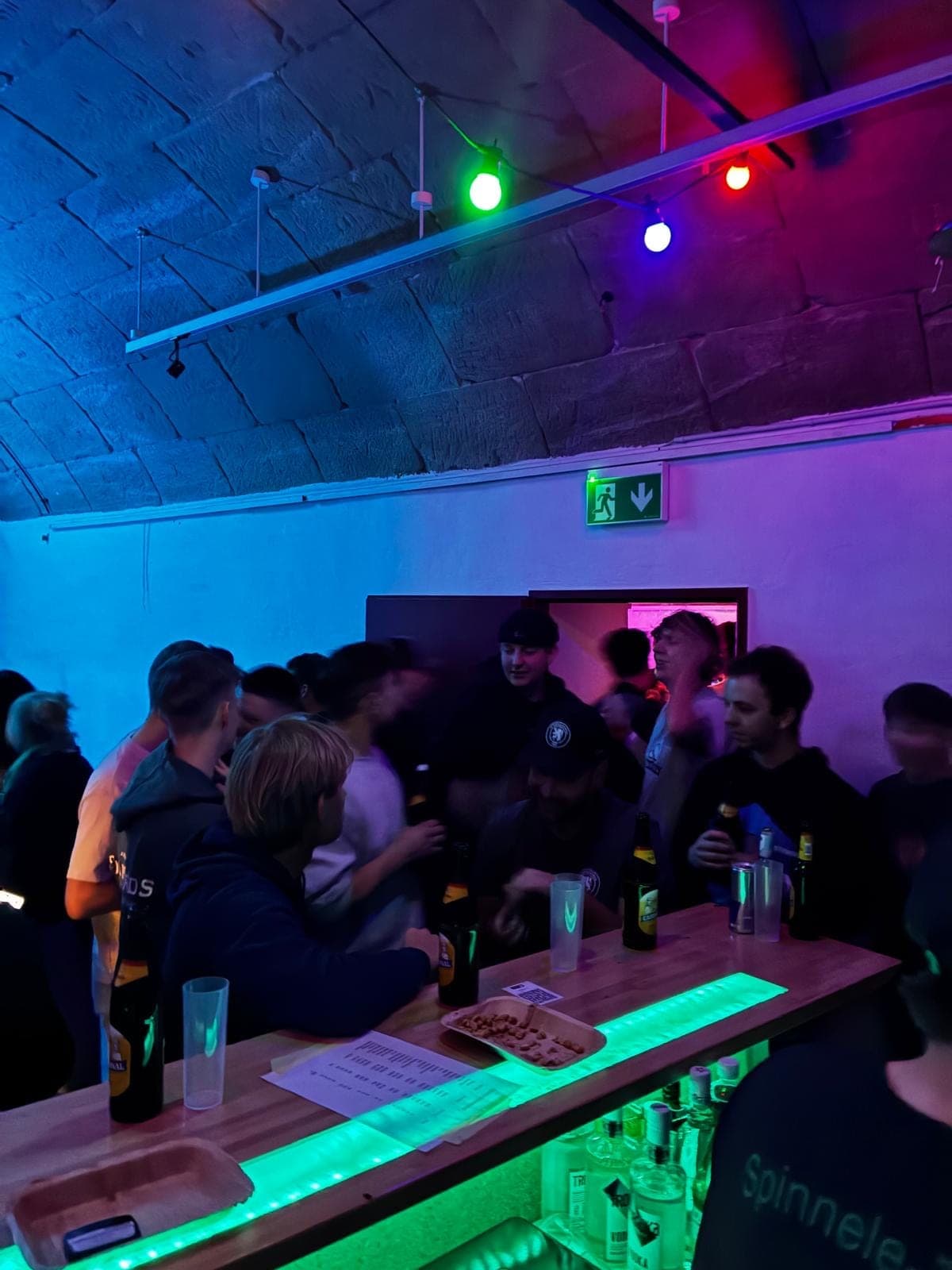 Gedränge an der grün beleuchteten Bar