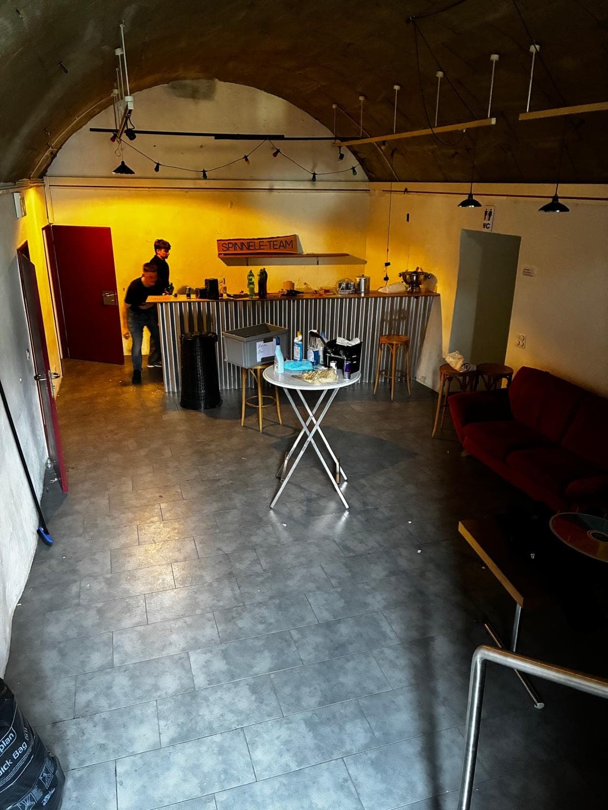 Der Keller vor der Party: Bar und Stehtische im warmen Licht